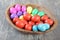 Multicoloured Easter eggs in a beautiful wooden bowl