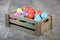 Multicoloured Easter eggs in a wooden box