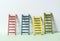 Multicoloured ladders on wall. Pastel tones. Concept for success and growth