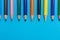 Multicoloured pencils on blue background, back to scool concept