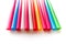 Multicoloured single-use plastic cocktail straws on a white background