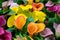 Multicoloured yellow, pink orange, purple calla flowers as background