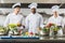 multicultural chefs at restaurant kitchen with vegetables