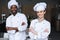 multicultural chefs standing with crossed arms and looking at camera