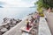 Multicultural community enjoying summer weather on beach along Geneva lakeside in Montreux, Switzerland