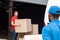 multicultural delivery men in red and blue uniform with cardboard