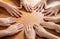 Multicultural hands man woman children in circle on brown wooden background.