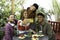 Multicultural happy friends having fun taking group selfie portrait outside in the garden during a coffee break - Mixed race young