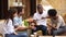 Multicultural happy friends laughing eating pizza in restaurant outdoor