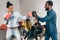 multicultural male friends doing sparring in boxing gloves and two women cheering