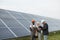 Multicultural people checking temperature of solar panels