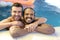 Multicultural same sex couple in the swimming pool