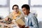 multicultural teen boys reading book about soldering motherboard