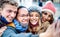 Multicultural travelers taking happy selfie wearing face mask and winter clothes - New normal lifestyle concept with milenial