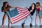 multicultural young women with american flag against