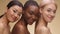 Multiethnic beauty. Fashion portrait of three diverse ladies with bare shoulders posing together and smiling to camera