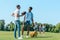 multiethnic boys playing with rugby ball while classmates walking behind