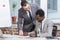 multiethnic businessmen smiling and signing document