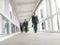 Multiethnic Businessmen Walking In Office Corridor