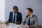 Multiethnic businessmen working at table with papers