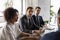 Multiethnic businesspeople brainstorm at meeting in office boardroom
