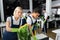 Multiethnic cleaners cleaning plant and table