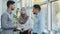 Multiethnic colleagues arab muslim woman in hijab and two Indian millennial male discuss corporate task. Diverse workers