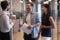 Multiethnic colleagues met in office hallway having informal positive conversation