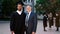 Multiethnic concept in the college garden posing in front of the camera mature man college professor and his graduate