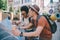 multiethnic couple of young tourists with map and coffee