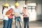 Multiethnic diverse group of engineers or business partners at construction site, working together on building`s blueprint