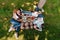 Multiethnic family eating and drinking while resting on plaid at picnic