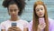 Multiethnic female teens chatting on smartphones, real communication lack