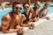 multiethnic friends in swimsuits and sunglasses resting