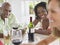 Multiethnic Friends With Wineglasses At Table