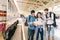 Multiethnic group of friends, backpack travelers, or college students using local map navigation together at train station