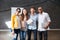 Multiethnic group of happy young business people standing in office