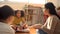 Multiethnic group of school children sitting on floor listening to Asian school teacher