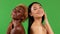 Multiethnic group of young woman isolated on green background, african american and asian woman with bare shoulders