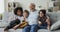 Multiethnic loving grandkids spend time with senior great-grandfather