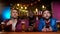 Multiethnic male friends watching football match in pub, upset with team losing