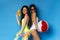 Multiethnic millennial girls enjoying summer vacation with pool party toys