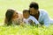 Multiethnic parents and mixed race baby in park. Multiracial family outdoor portrait. Biracial baby child on yard