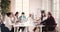 Multiethnic professional team use computers talk sit at meeting table