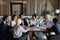 Multiethnic staff sit at table listen to asian female expert