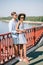 multiethnic stylish couple in sunglasses standing on bridge