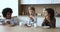 Multiethnic team of little friends drinking milk in kitchen