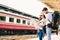 Multiethnic traveler couple using generic local map navigation together at train station platform. Asia tourism trip concept