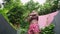 Multiethnic woman stretches in opulent tropical outdoor gym, warming up for training. Elegantly dressed in vibrant