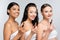 multiethnic women with bare shoulders smiling